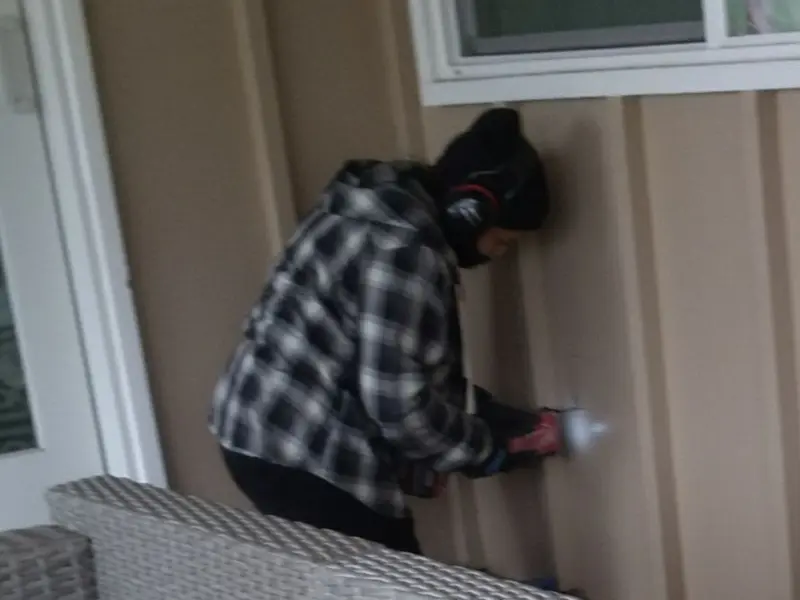 Professional electrician installing an exterior outlet in Clinton